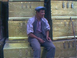 Seller of wooden chests for wedding dowries.  Kashgar, Xinjiang.