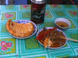 A typical Uyghur meal: sei (mutton stew, nan (bread) and tea.  Kashgar, Xinjiang.