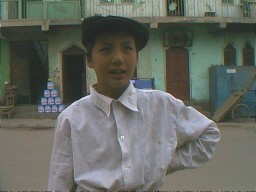 Abdul, a 10 year old Uyghur, greeted friends with a grave handshake and immediately touched his chest carrying the warmth of friendship straight to his heart. Kashgar, Xinjiang.