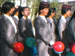 Tadjik hotel staff on parade for China's National Day. The woman with a green balloon is a Kazak (Cossack). Tashkurgan, Xinjiang.