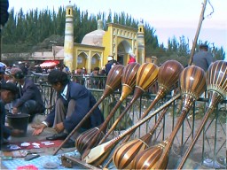 Seller of dutah (2-string instrument like a sitar) in front of the Id Kah Mosque. Kashgar, Xinjiang.