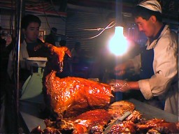 This baked goat was in a food stall on Food Street which in the daytime changed back to ordinary WuYi Street. Urumuqi, Xinjiang. 