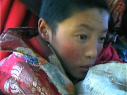 This 10 year old novice monk is from the Nyingma Order or Old School founded by Guru Rinpoche who came to Tibet from India in the 8th or 9th century.  Manigange, Qinghai.
