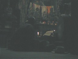 Two monks praying in temple