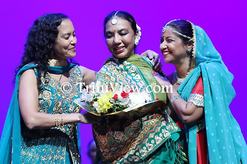 (Center): Mondira Balkaransingh receives the shawl of honour during an Angwastram ceremony
