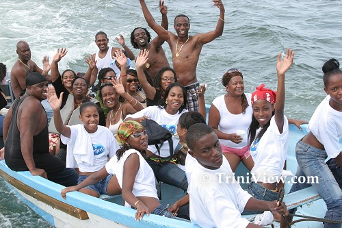 Pageanteers and other Carenage residents enjoying the ride on the pirogue