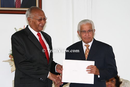 LEFT: His Excellency Professor George Maxwell Richards presents the Instrument of Appointment to Opposition Leader Basdeo Panday
