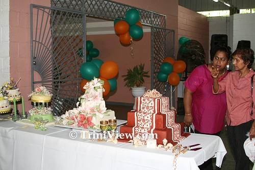 Patrons looking at fancily decorated wedding cakes
