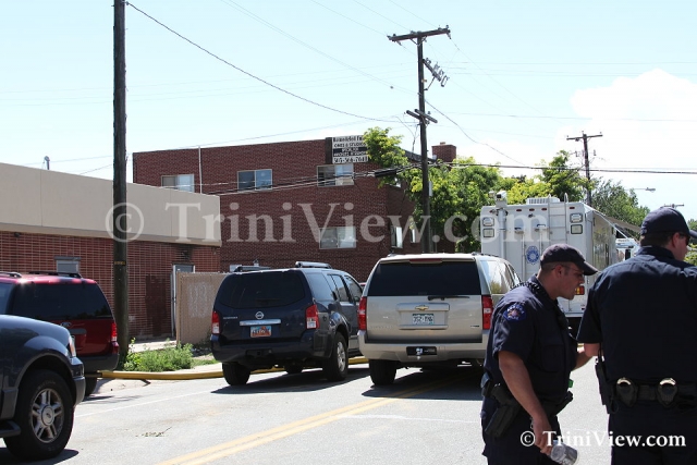 Police and other officials' vehicles the suspect's apartment