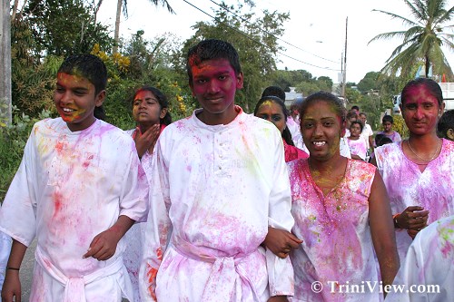Members of the Shiv Mandir Youth Group covered in abeer along Ragoonanan Road
