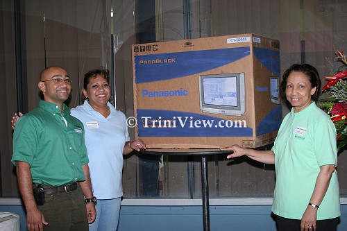Denzil Ali, poses with this Grand Door Prize, a flat screen television