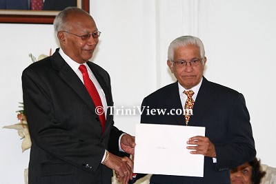 LEFT: His Excellency Professor George Maxwell Richards presents the Instrument of Appointment to Opposition Leader Basdeo Panday