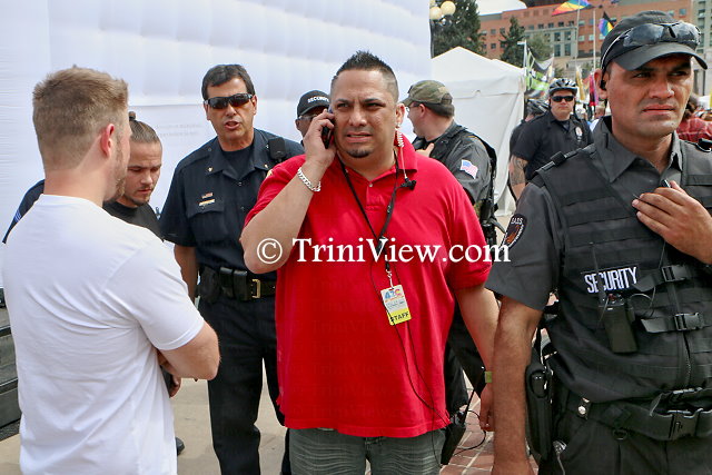Event organizer Miguel Lopez (in red) among police officers in the process of shutting down the temporary enclosure