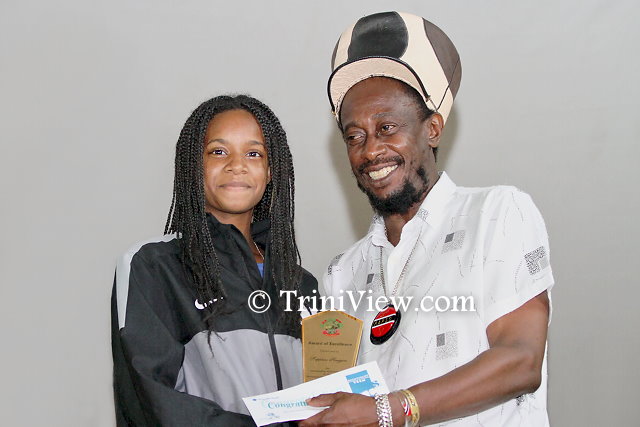 Lutalo 'Brother Resistance' Masimba presents an award to a  SEA student