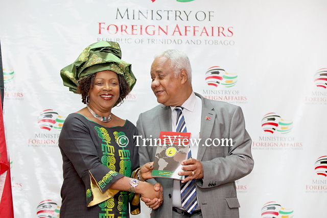 Dr. Verene Shepherd presents a copy of her book to to His Excellency Mervyn Assam
