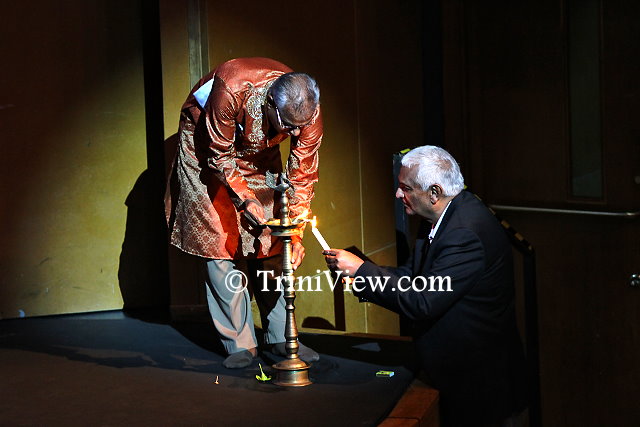 (R): Minister of Foreign Affairs Winston Dookeran joins Mr. Vishnu Musai, Chairman of the Nrityanjali theatre in the lighting of the lamp