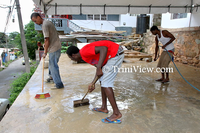 Residents of Scorpion Alley, Carenage assist with the preparation  for the party