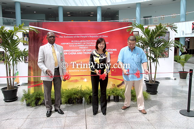 General Operations Manager of Piarco International Airport Oswald Bruce, Counsellor of the Chinese Embassy Ms. Lan Heping, and Managing Director of Shanghai Construction Group International Michael Zhang cut the ribbon officially launching the exhibition