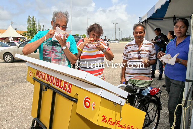 Patrons enjoying doubles and red solo soft drink