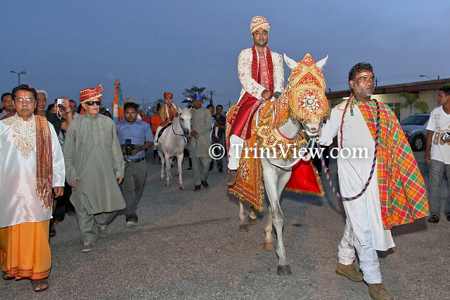 The dulaha, Rishi Sinanan, accompanied by his sarbala, seven year-old Chris Mohammed