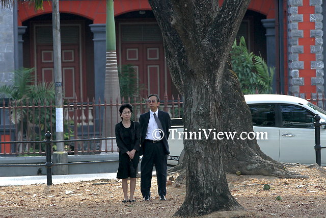 Japanese Embassy representatives view the proceedings from a distance