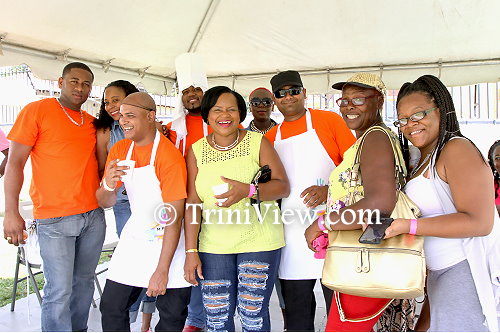 Officers from the north-east division (orange t-shirts) share a photo moment with patrons