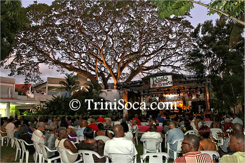 Patrons gather under the trees at Hotel Normandie for the Roots at Forty event