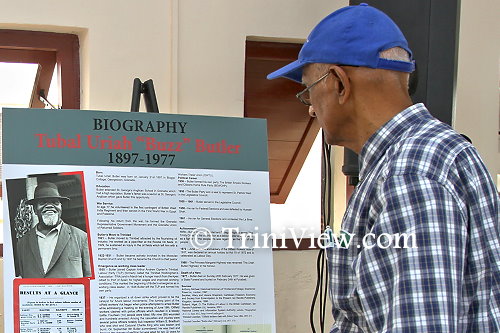 An attendee viewing Tubal Uriah ‘Buzz’ Butler's biography in the exhibition