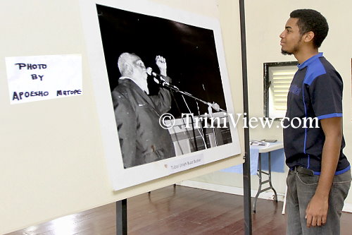 Butler's great-grandson, Christon Searles, admires an old photograph of his great-grandfather delivering one of his public speeches