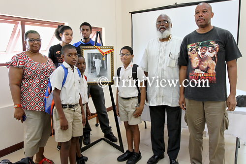 Caption: Butler's grandchildren and great-grandchildren, Bethlehem Boys R.C. students, and Professor Winston Suite (in white)