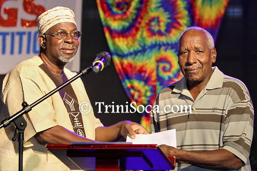 Lance Baptiste, brother of the late Anum Bankole, accepts a cheque on behalf of the Anum Bankole Foundation for Youths and the Arts fund from NJAC chairman Aiyegoro Ome